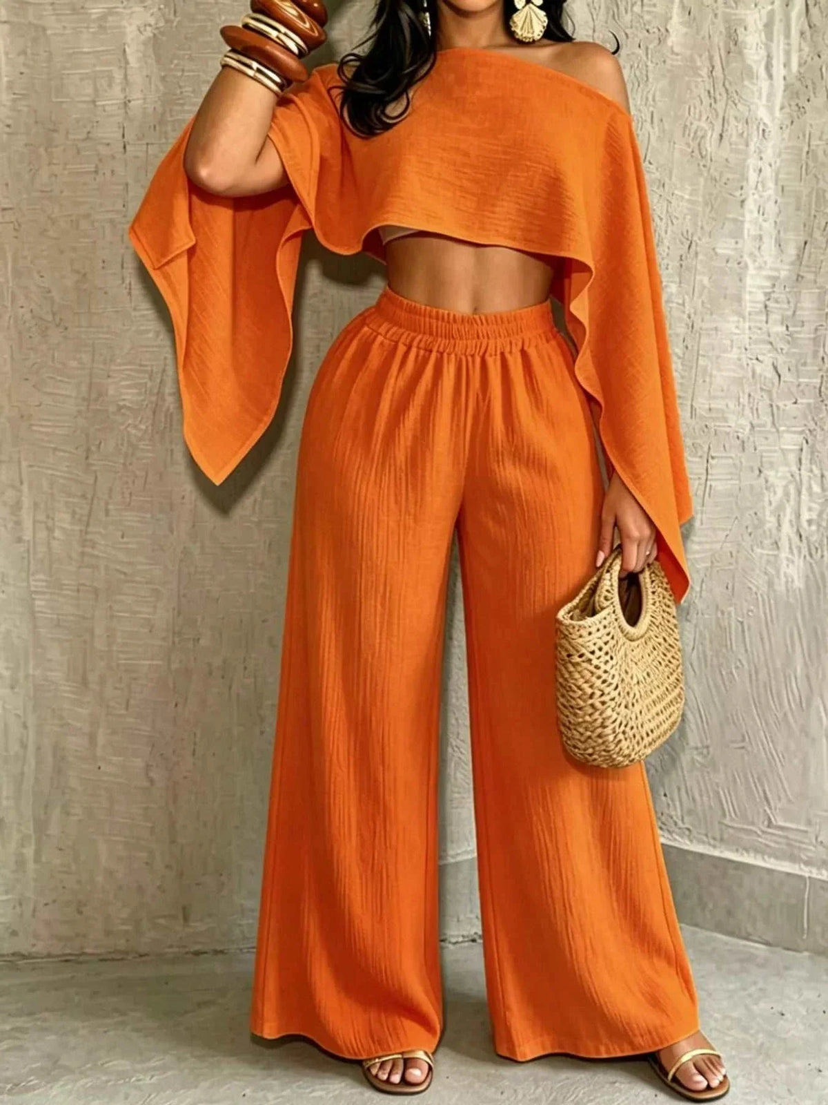 Boat Neck Crop Top and wide-leg pants set in orange ribbed fabric, with an asymmetrical draped top and flowing trousers.